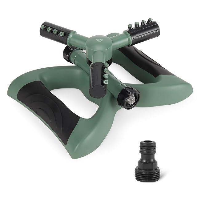 Green three-arm rotating lawn sprinkler on a weighted base