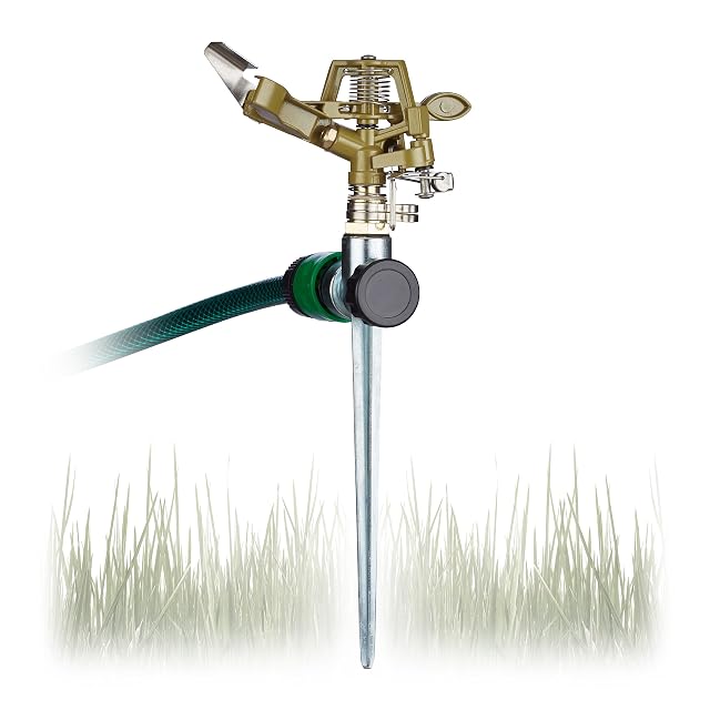 Green metal impulse sprinkler on a ground spike